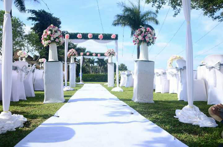 Wedding ceremony aisle with a floral arch at Sienna Beach Hotel