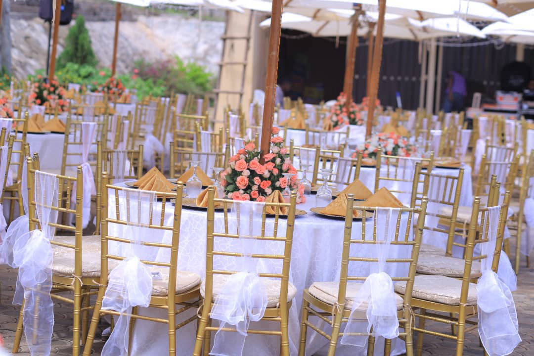 Reception tables set with gold chiavari chairs and floral centrepieces at Sienna Beach Hotel